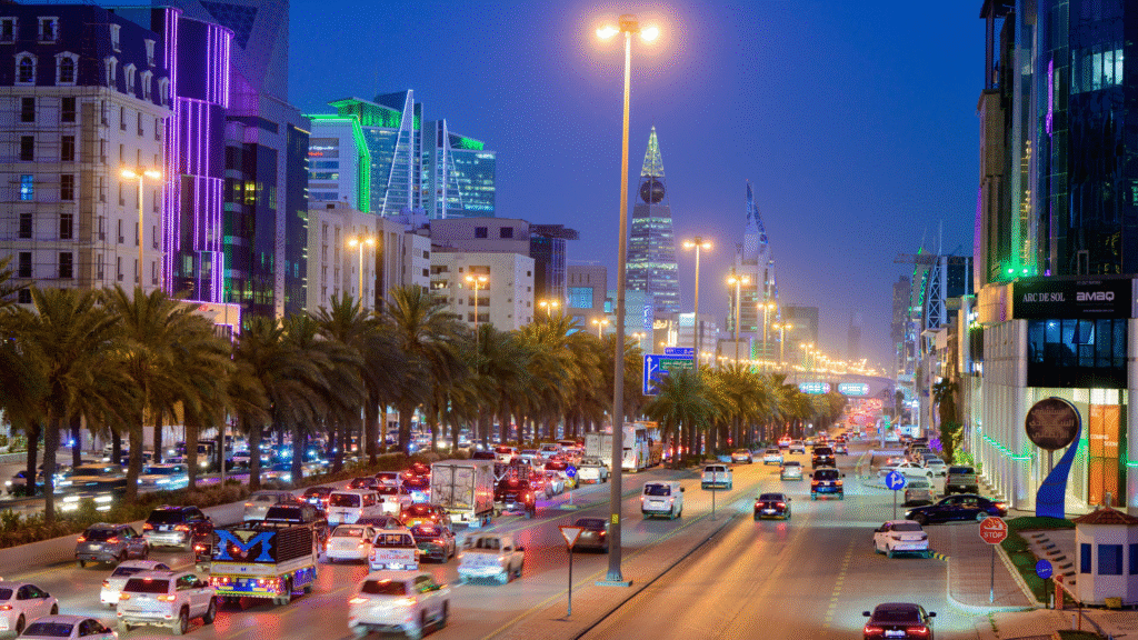 Night traffic on a busy Riyadh street, demonstrating the infrastructure managed by the Transport General Authority.
