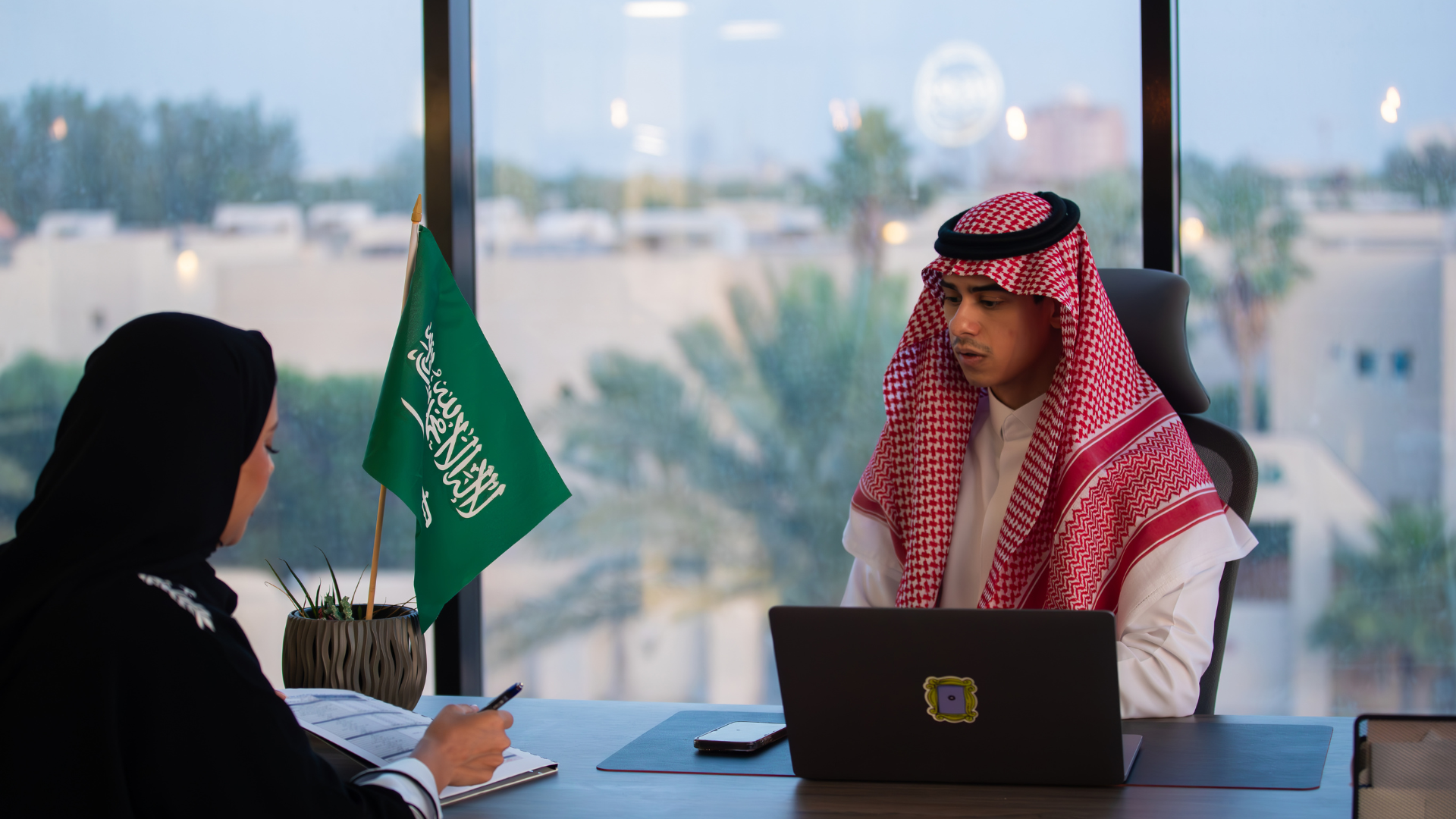 Expatriates in Saudi Arabia discussing employment contract under labor law