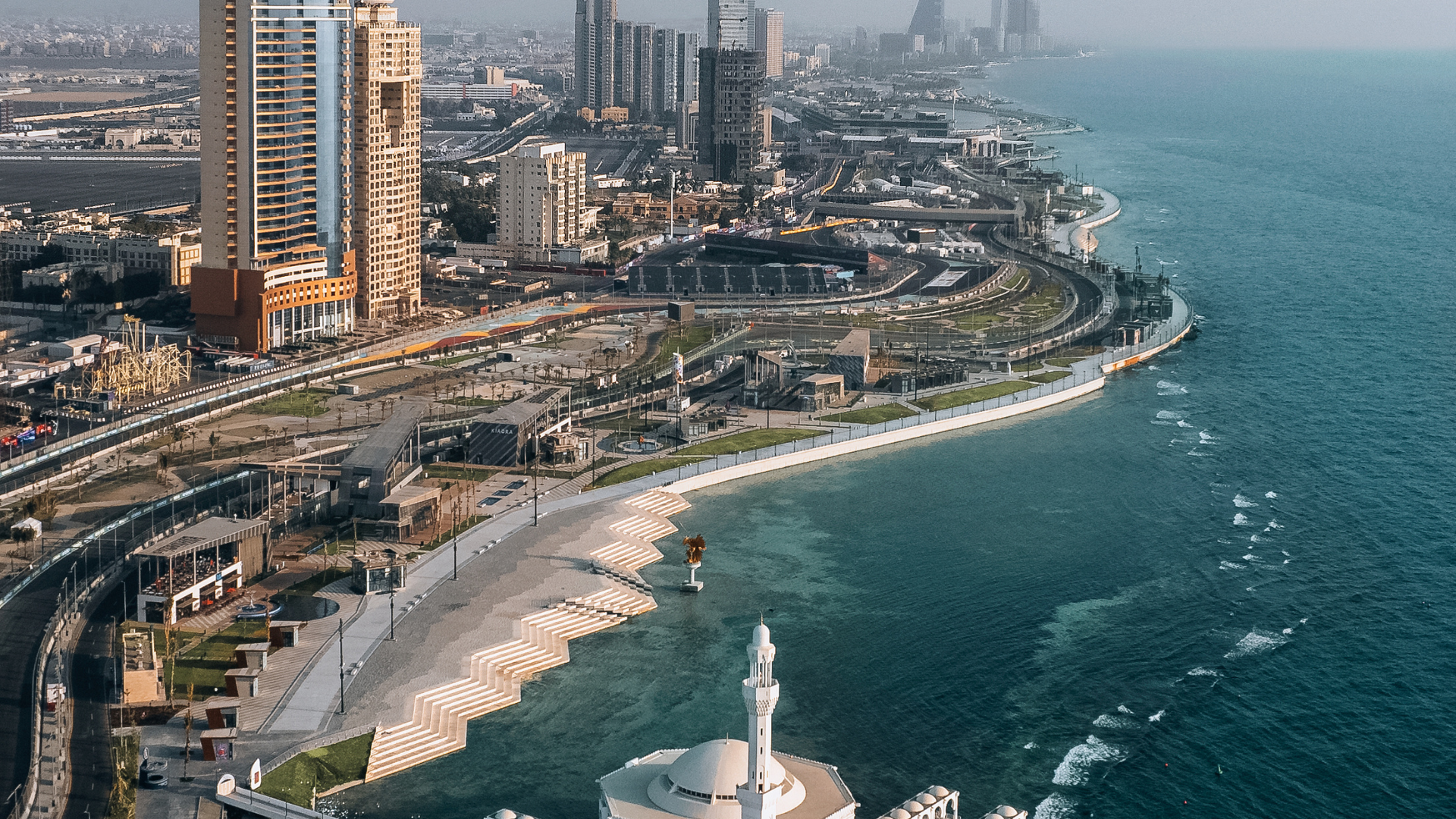 Job Vacancies in Jeddah for expatriates - 1Skyline of Jeddah with modern skyscrapers and Red Sea coastline, representing job opportunities for expatriates.